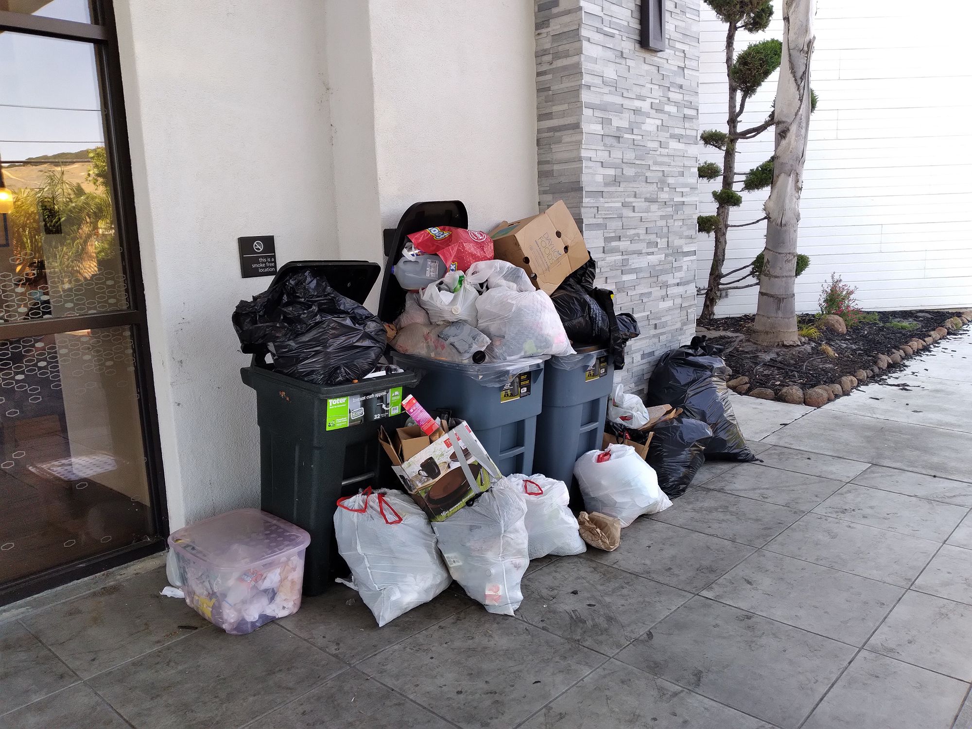 Trash piled outside the entrance to the Hampton Inn on May 8, 2021. 