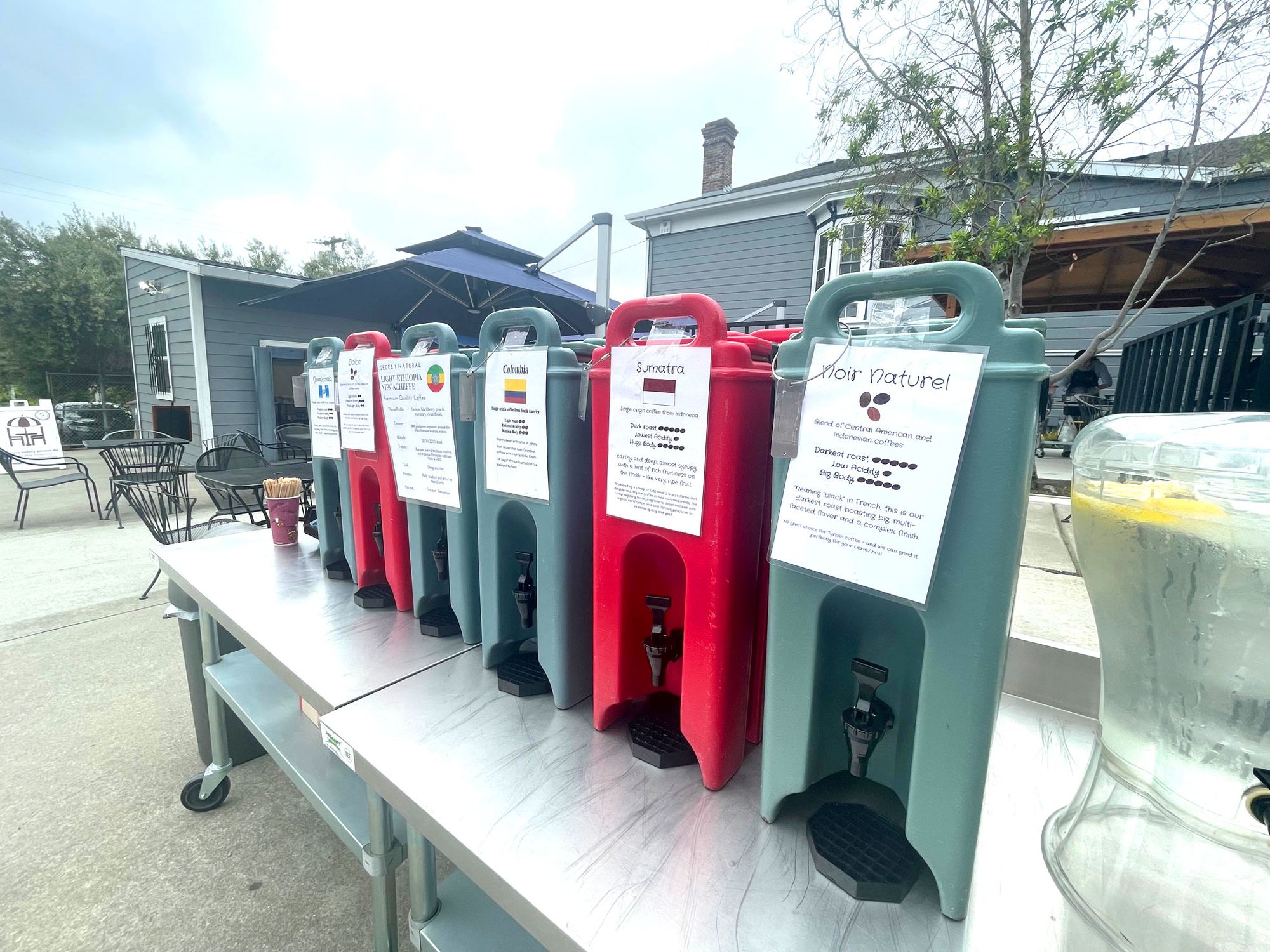 Six different coffees are dispensed from red or grey containers at the free Saturday tasting at Moschetti Artisan Coffee Roaster in Vallejo