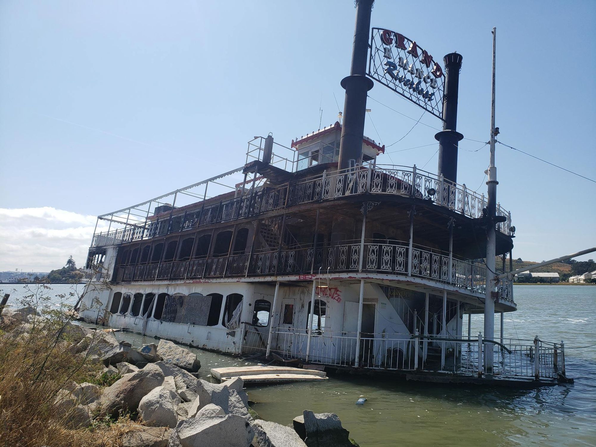The Grand Romance riverboat was left submerged after a fire on Saturday. 