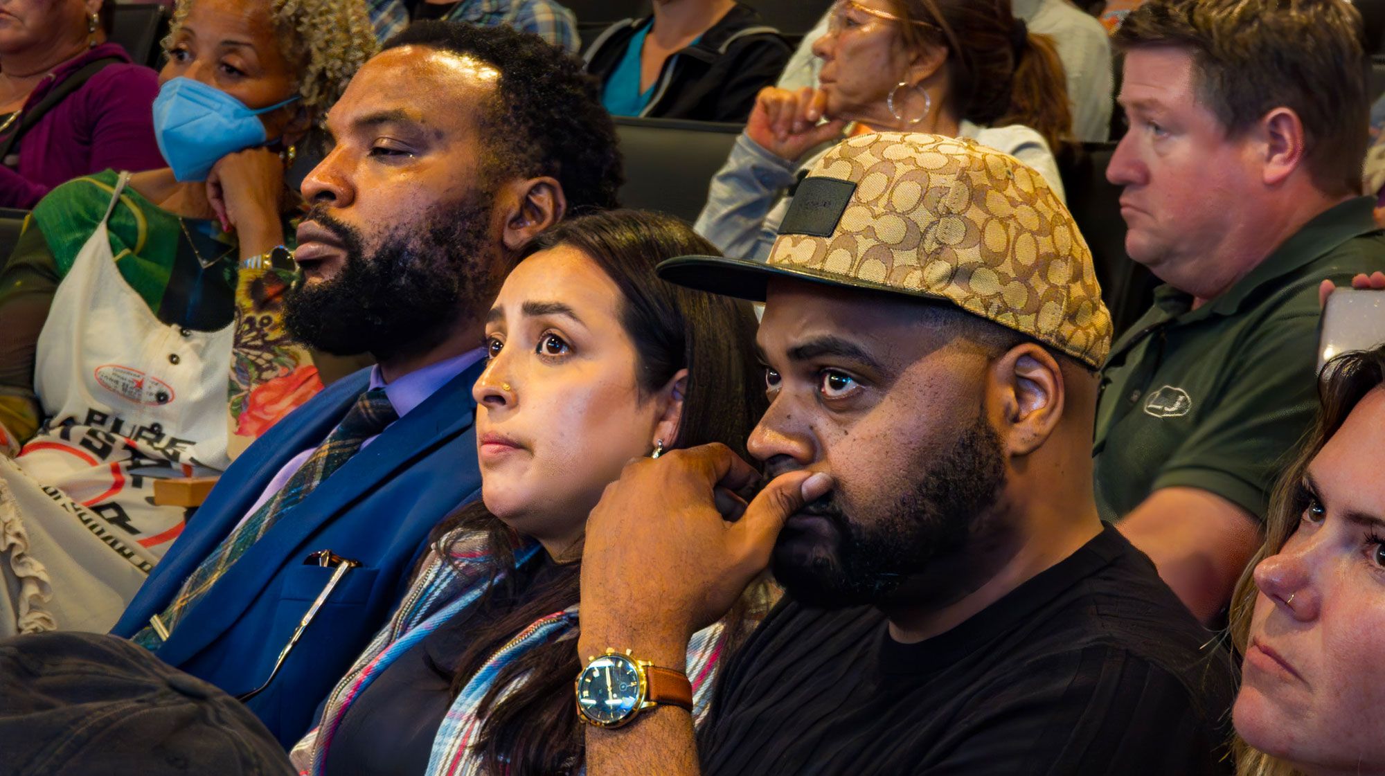 Attorney Lee Merritt, Michelle Monterossa and Dwayne Thompson watch Tuesday's city council meeting. 