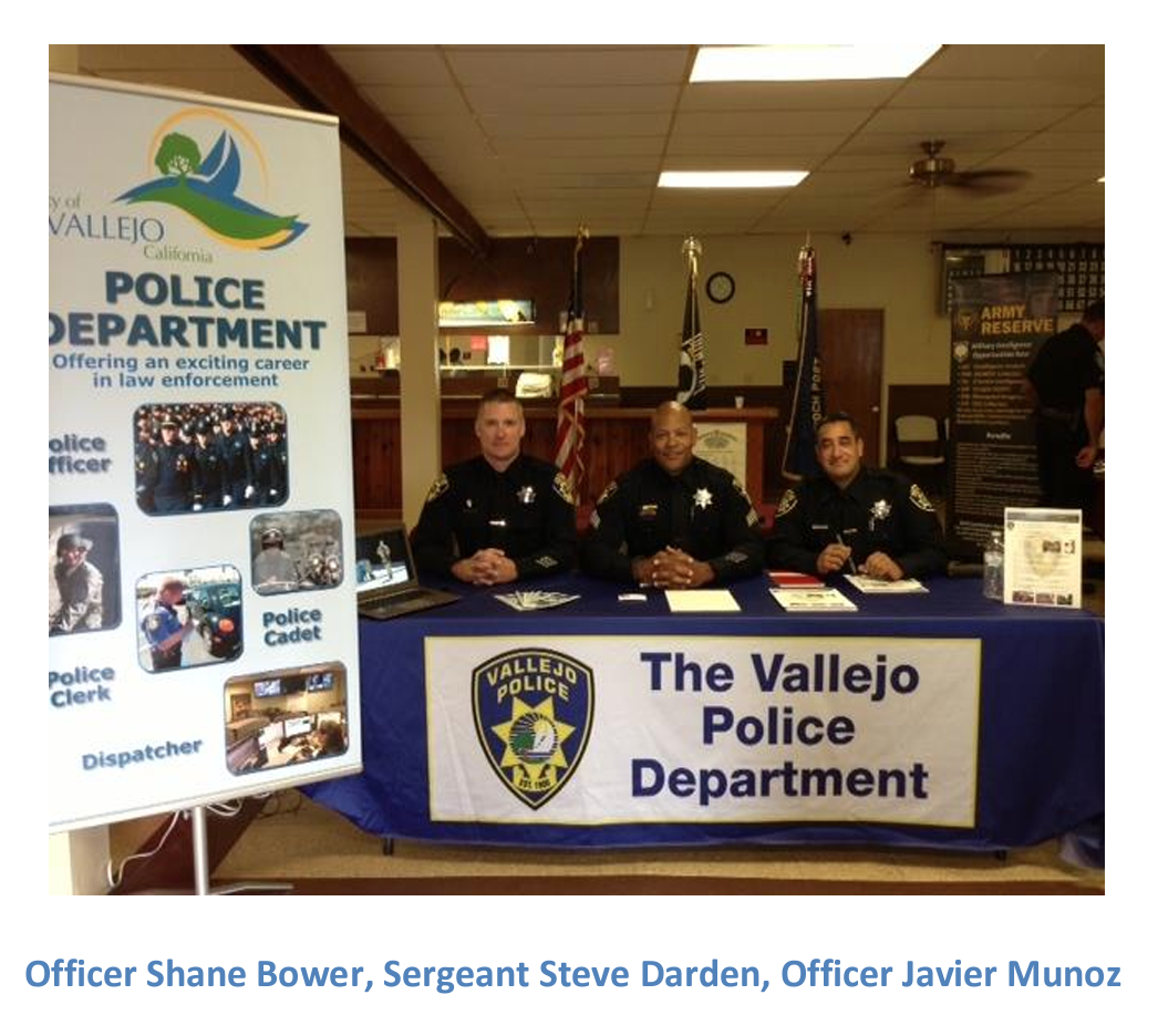 Vallejo police officers sitting at a table at a recruiting event in 2013.