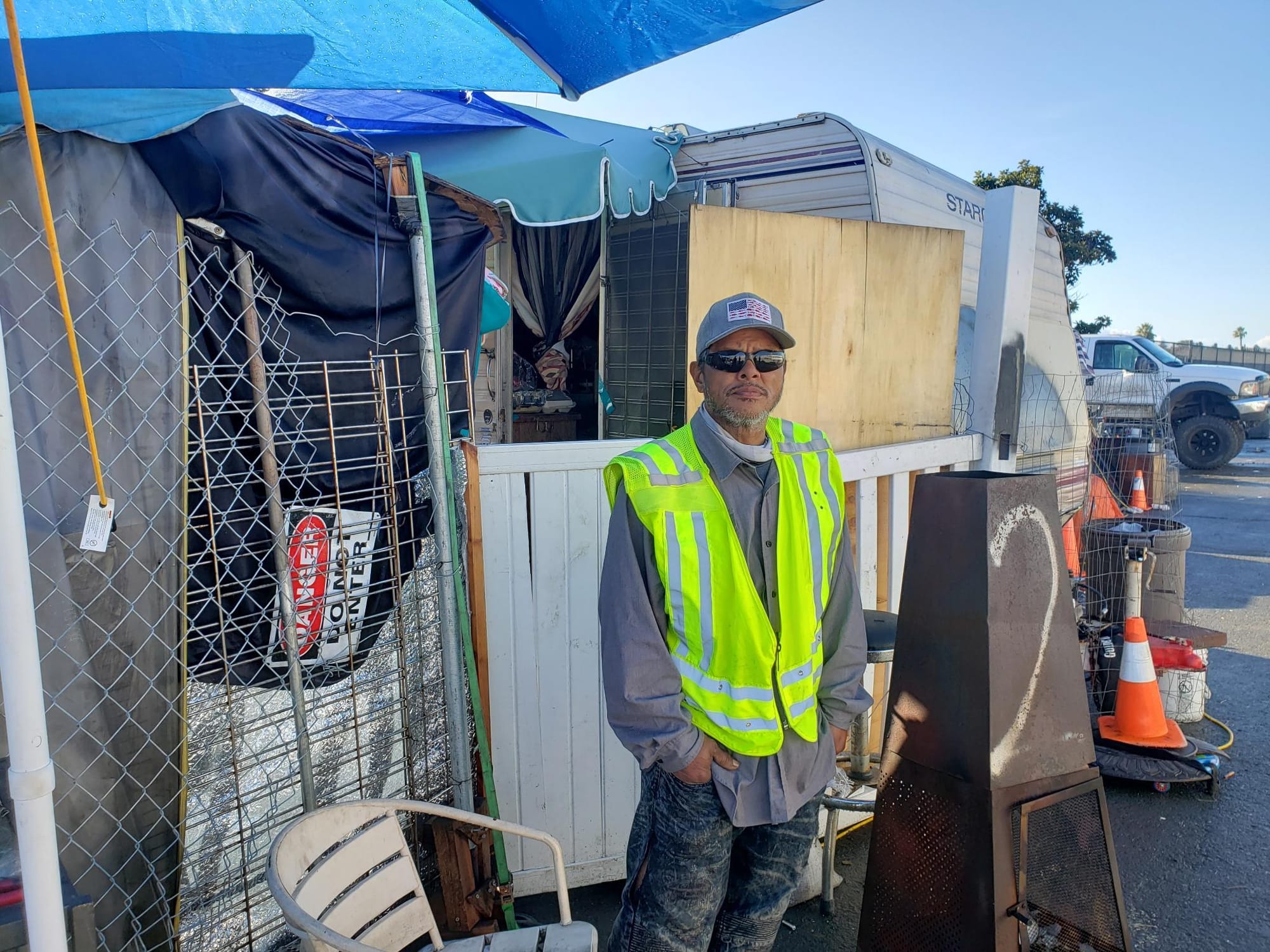 Victor Meno stands outside of his shelter on Enterprise Street shortly before it was cleared by city workers. 