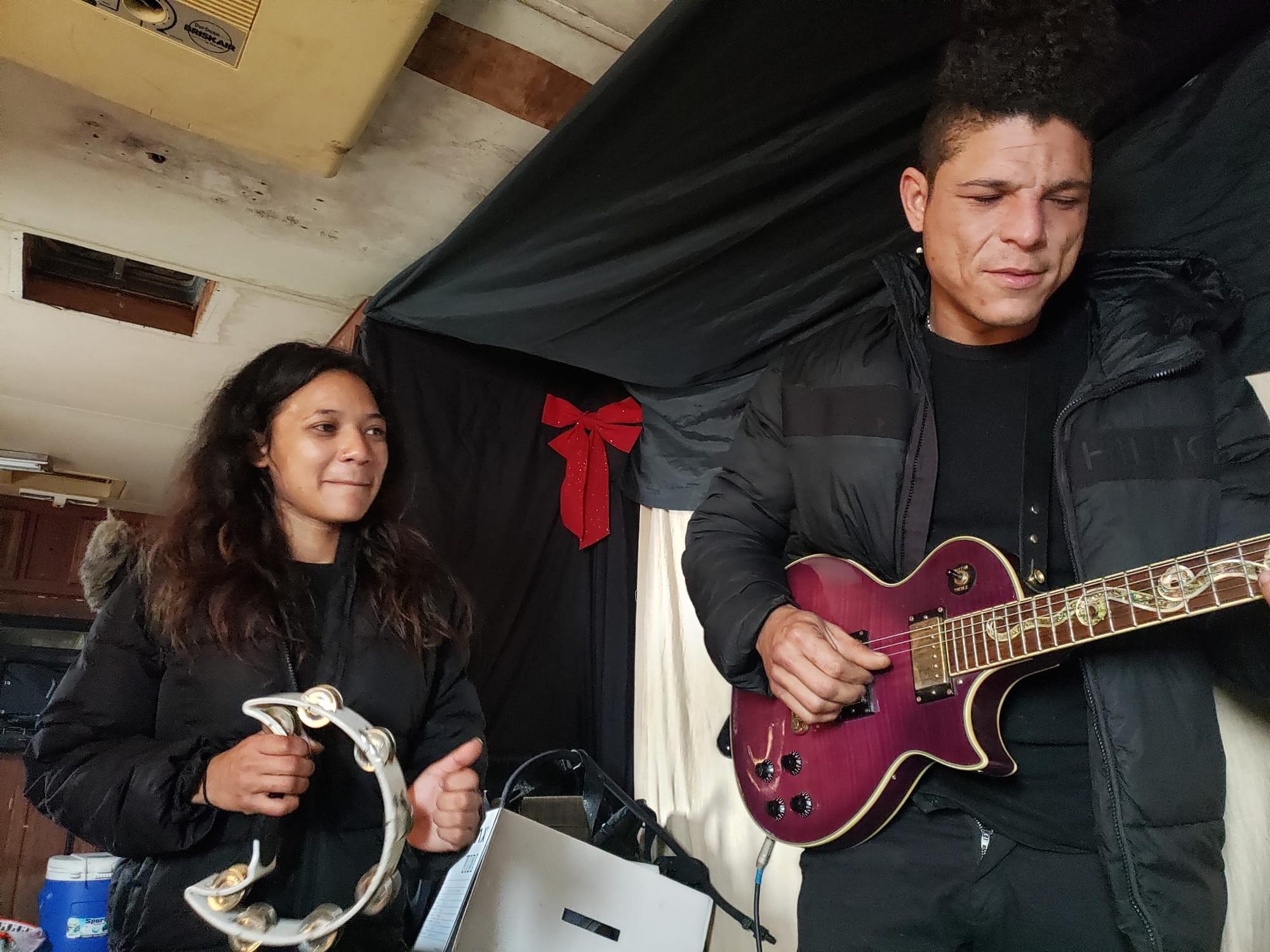 Simar Pacedo Solorzano and Jose Campos Cordova play music in their RV at Vallejo's boat launch. 