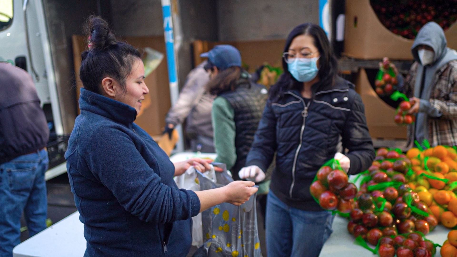 A program recipient receives groceries at the Food Bank of Contra Costa and Solano's community produce program.