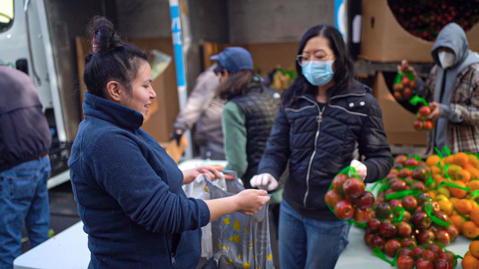 A client receives food from the food bank. 