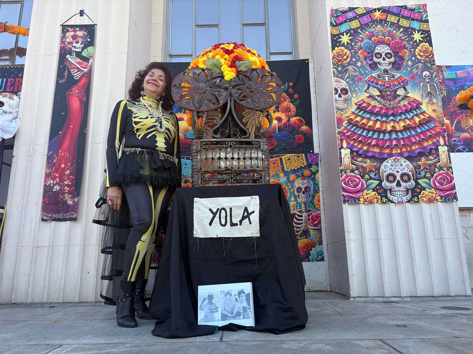 Ali Gomez poses next to a metal art piece dedicated to her relative.